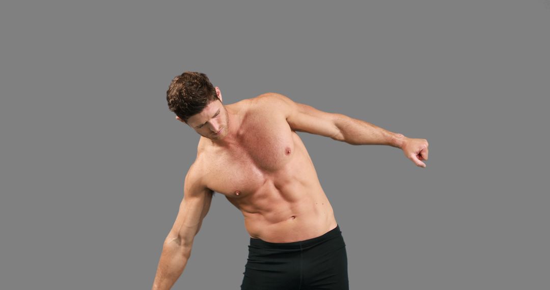 Fit Man Performing Dynamic Stretching Exercise Isolated on Gray Background - Free Images, Stock Photos and Pictures on Pikwizard.com