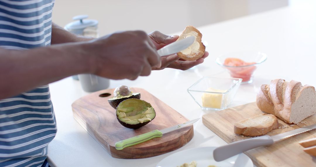 Man Preparing Avocado Toast Breakfast in Modern Kitchen