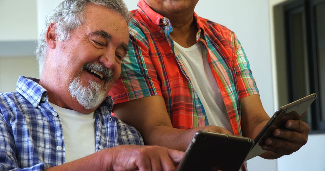 Laughing Senior Men Using Digital Tablets - Free Images, Stock Photos and Pictures on Pikwizard.com