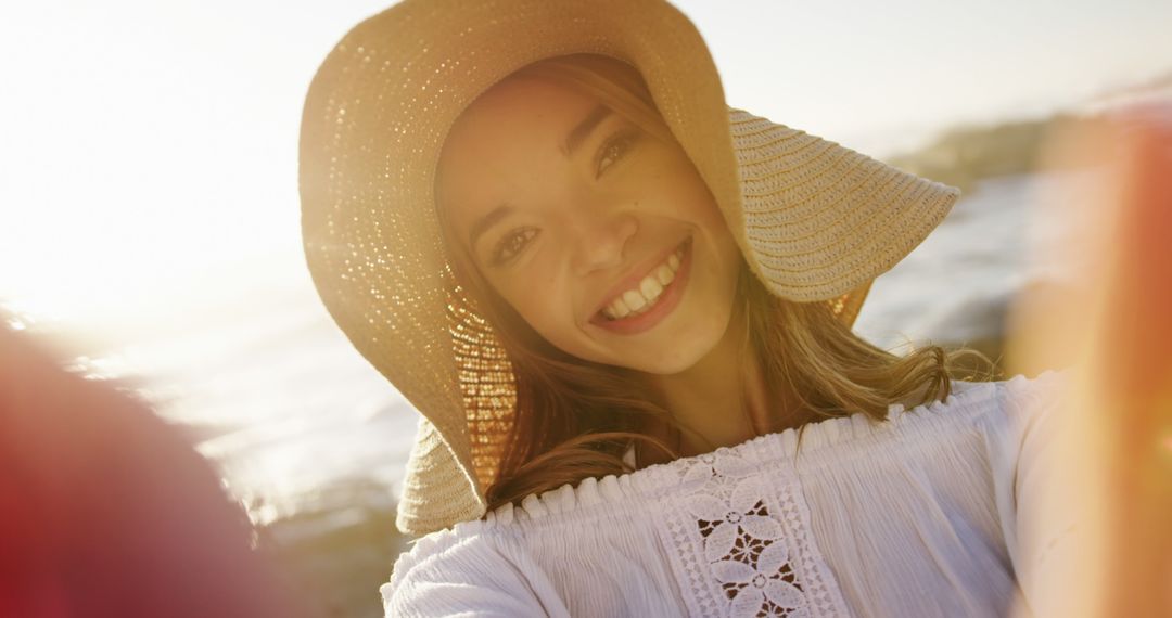 Young Woman Smiling in Sunlight Wearing Sun Hat Close-Up - Free Images, Stock Photos and Pictures on Pikwizard.com