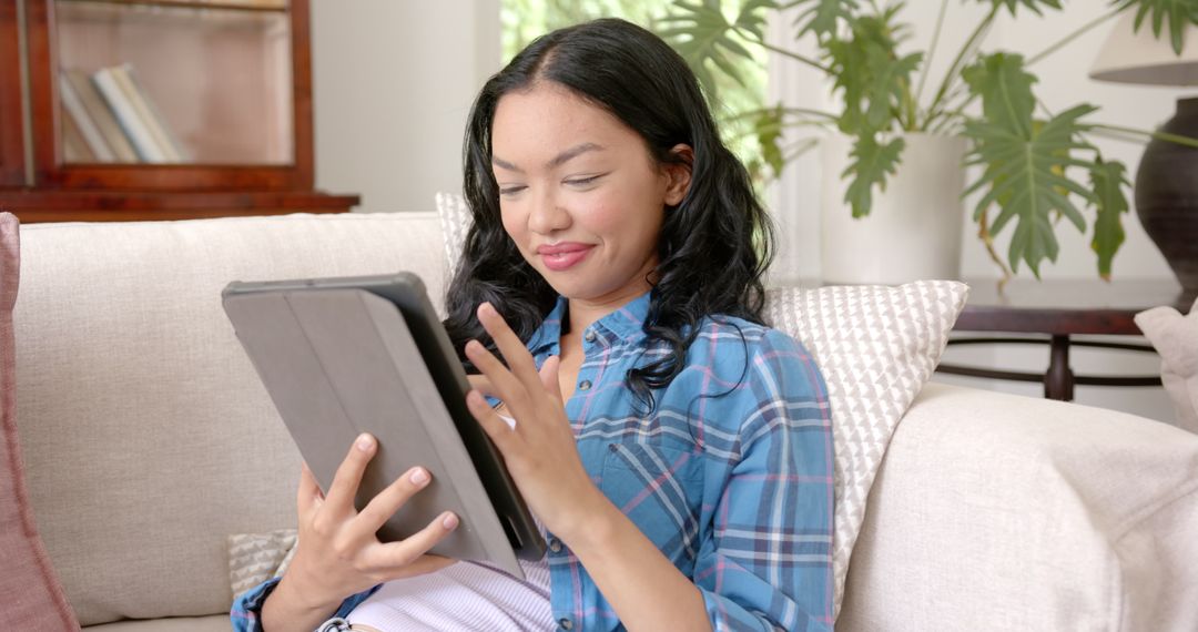 Young Woman Using Tablet in Relaxed Home Environment