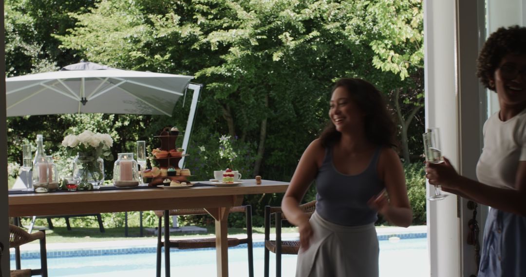 Woman Setting Up Elegant Poolside Event with Desserts and Drinks