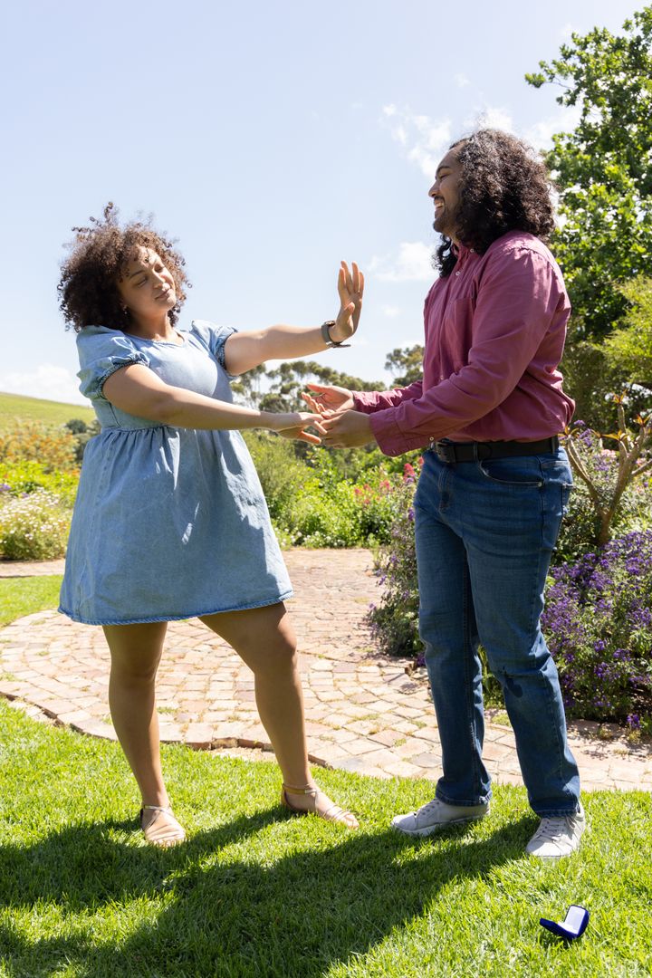 Couple Celebrating Romantic Moment in Scenic Garden Setting