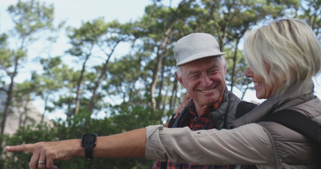 Senior Couple Smiling and Hiking Together in Forest