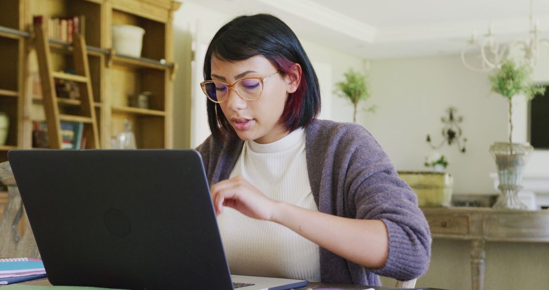Teenage Girl Smiling and Using Laptop at Home