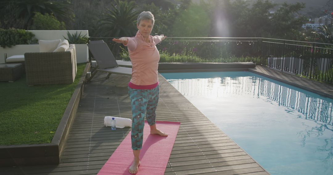 Mature Woman Practicing Yoga on Outdoor Deck Near Swimming Pool - Free Images, Stock Photos and Pictures on Pikwizard.com