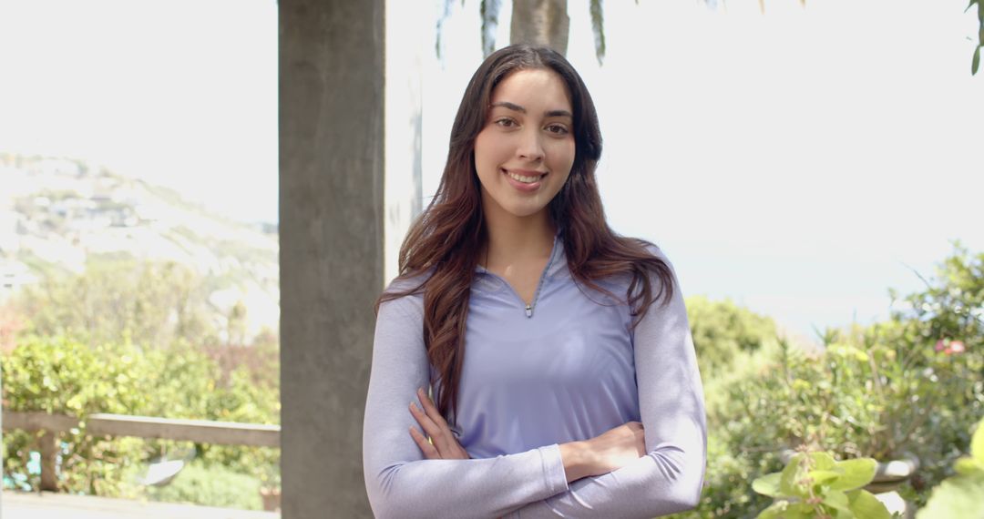 Woman Enjoying Serene Hillside Garden View in Casual Outfit