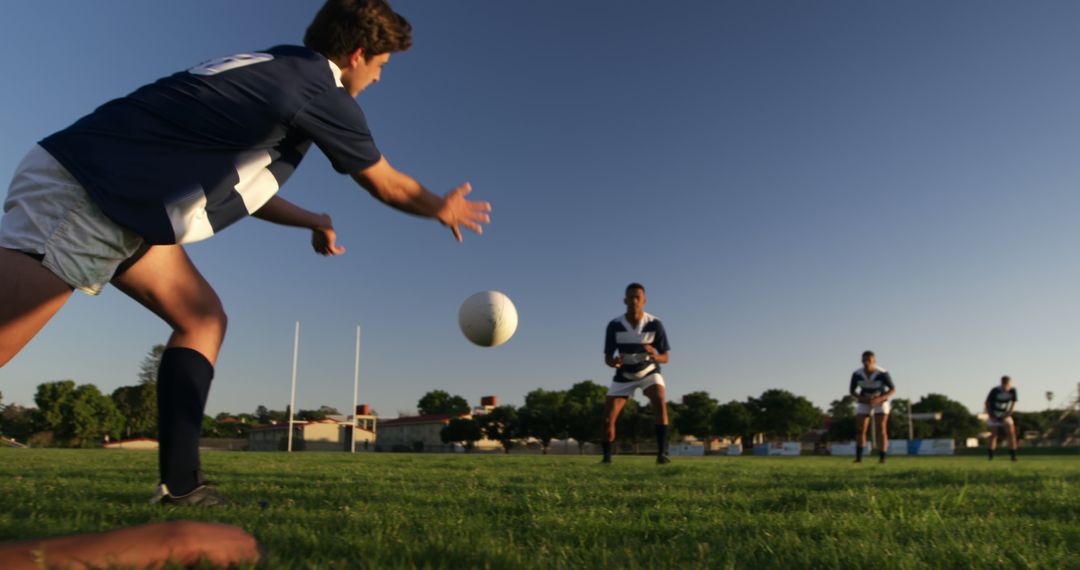 Young Athletes Playing Rugby on Field at Sunset - Free Images, Stock Photos and Pictures on Pikwizard.com