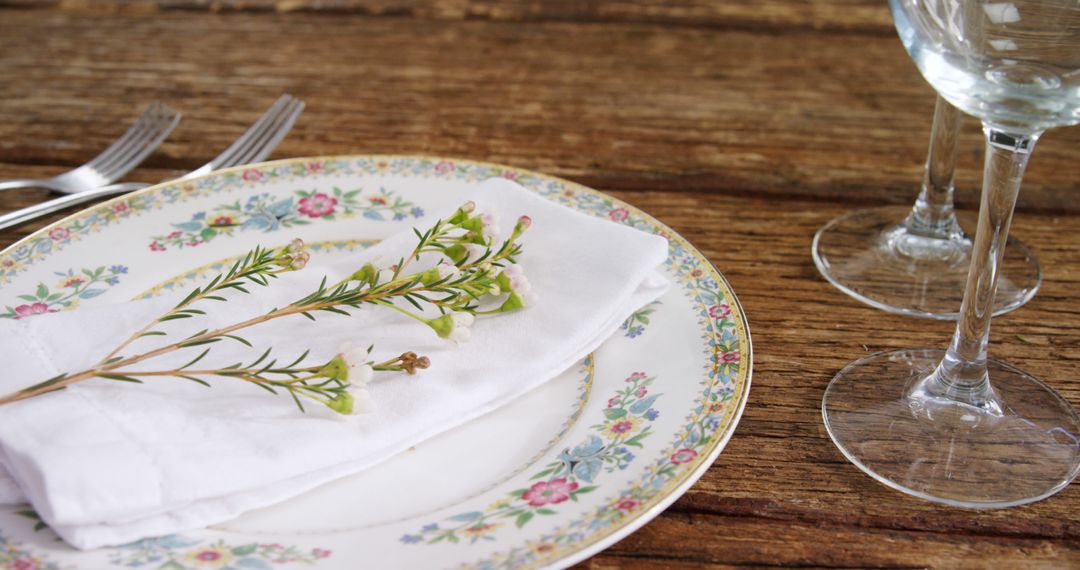 Elegant Table Setting with Floral Plate and Wine Glasses - Free Images, Stock Photos and Pictures on Pikwizard.com