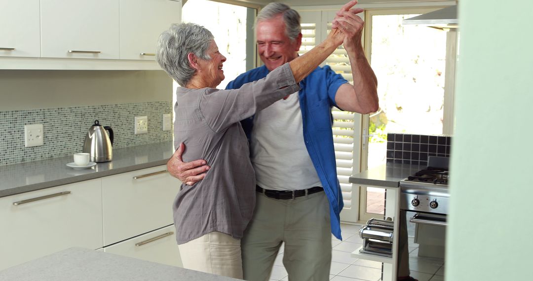 Elderly Couple Dancing in Modern Kitchen - Free Images, Stock Photos and Pictures on Pikwizard.com