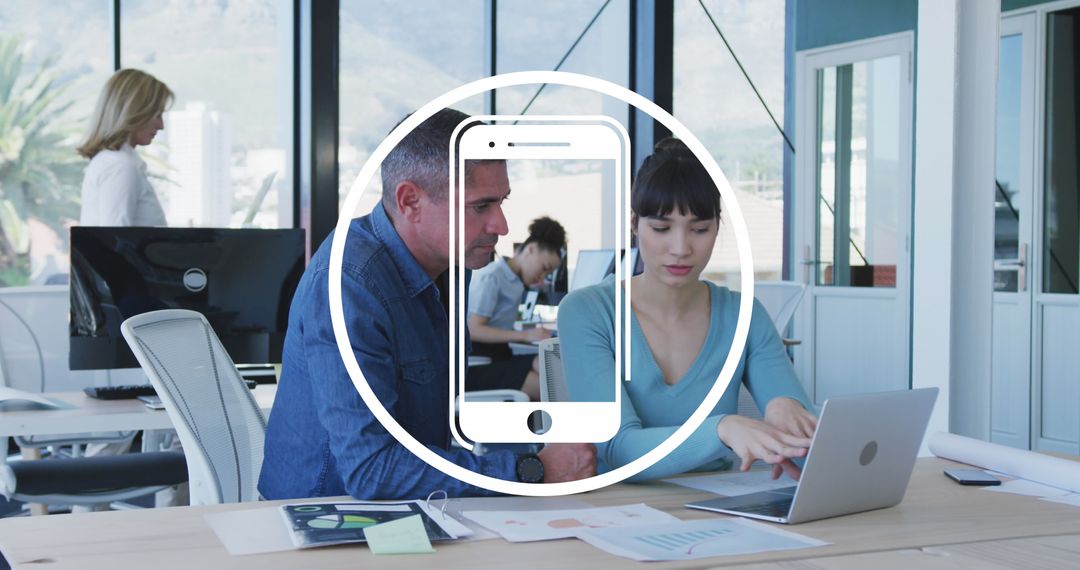 Diverse Team Collaborating on Laptop at Modern Office Workspace