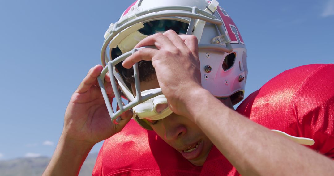 Football Player Adjusting Helmet During Game - Free Images, Stock Photos and Pictures on Pikwizard.com