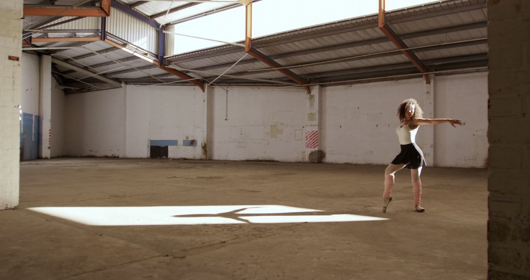 Ballerina Gracefully Dancing in Abandoned Warehouse