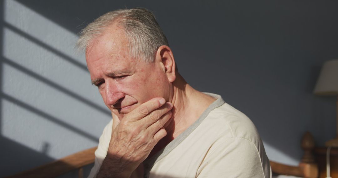 Elderly Man Experiencing Stress in Natural Light - Free Images, Stock Photos and Pictures on Pikwizard.com