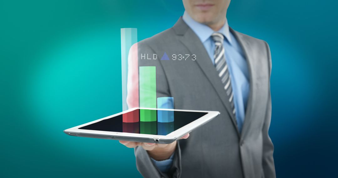 Businessman holding tablet with holographic financial graphs - Free Images, Stock Photos and Pictures on Pikwizard.com