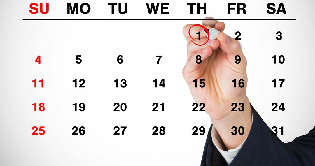 Hand Marking January 1st on Calendar for New Year Resolutions