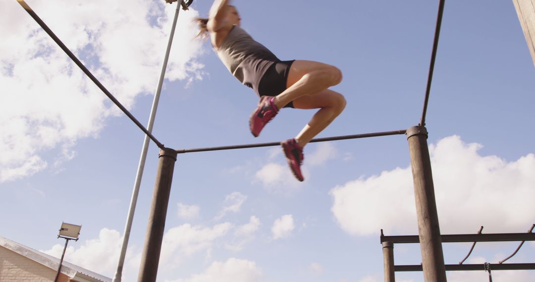 Young Woman Training on Outdoor Gymnastics Bars Under Blue Sky - Free Images, Stock Photos and Pictures on Pikwizard.com