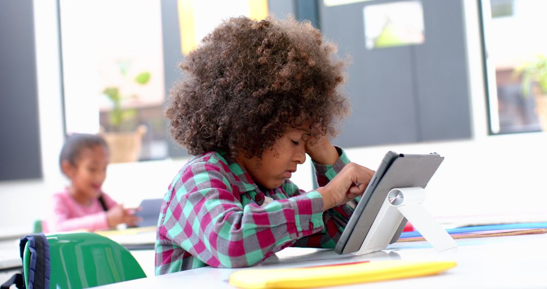 Young Boy Using Tablet for Digital Learning in Classroom