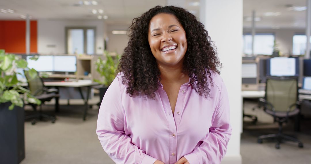 Confident African American Woman Smiling in Office Environment - Free Images, Stock Photos and Pictures on Pikwizard.com