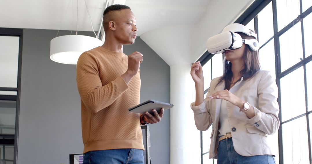 Colleague Interaction with VR Headset in Modern Office