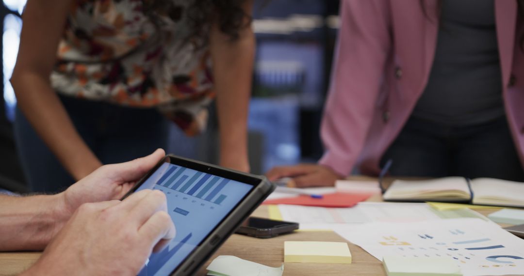 Business Team Analyzing Data on Tablet in Office Meeting