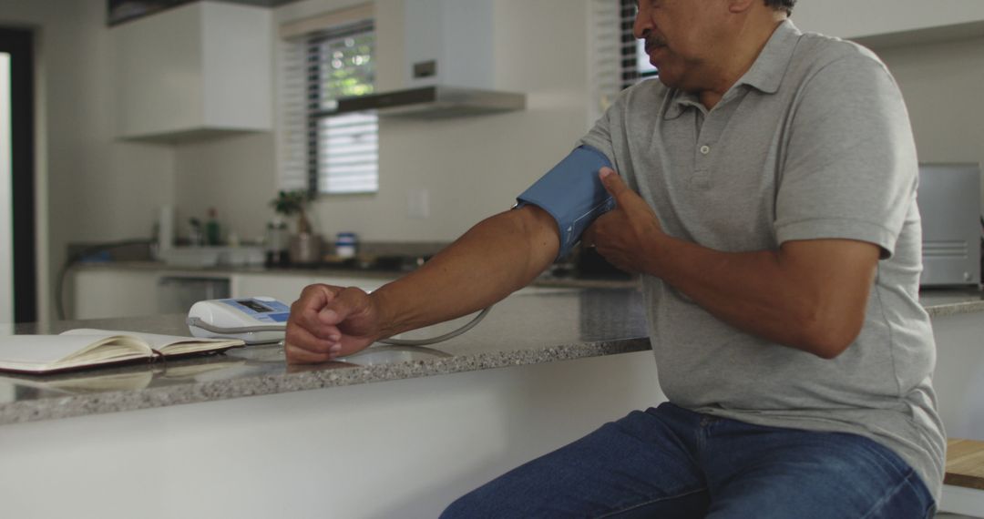 Middle-Aged Man Checking Blood Pressure at Home - Free Images, Stock Photos and Pictures on Pikwizard.com