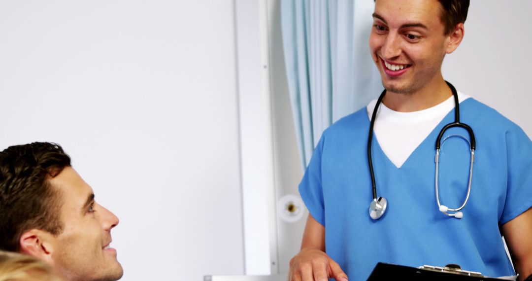 Male Nurse Smiling and Communicating with a Patient - Free Images, Stock Photos and Pictures on Pikwizard.com