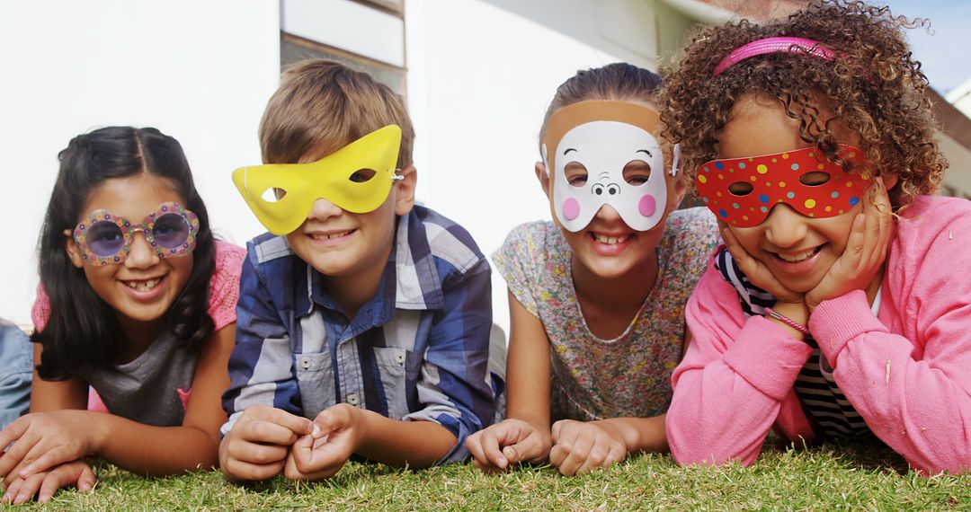 Diverse Children Wearing Colorful Masks Outdoors on Grass - Free Images, Stock Photos and Pictures on Pikwizard.com