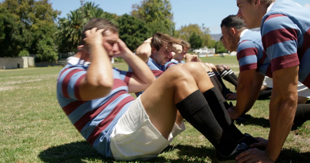 Rugby Players Performing Sit-ups during Training on Field - Free Images, Stock Photos and Pictures on Pikwizard.com