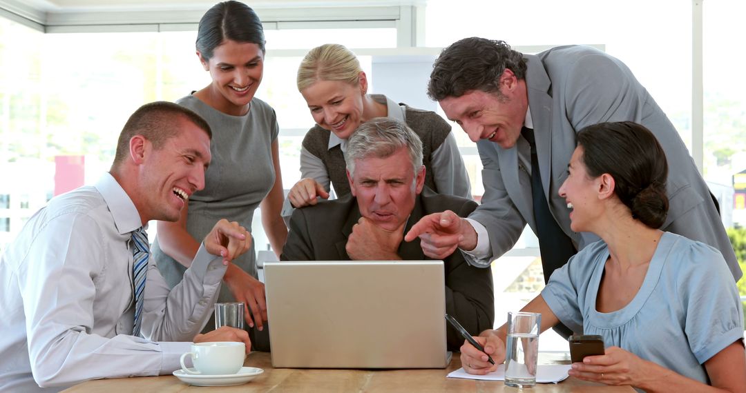 Team of Colleagues Collaborating on Laptop in Bright Office - Free Images, Stock Photos and Pictures on Pikwizard.com