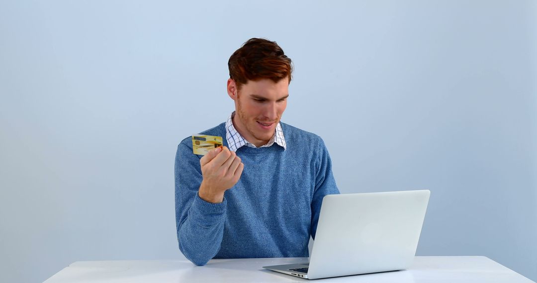 Young Man Holding Credit Card and Using Laptop for Online Shopping - Free Images, Stock Photos and Pictures on Pikwizard.com