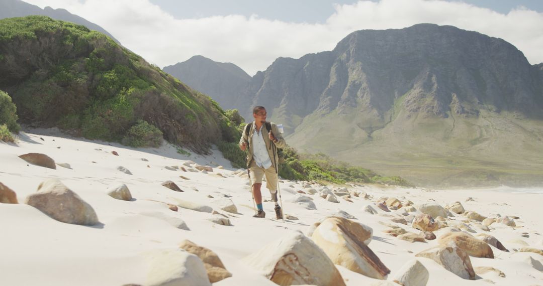 Man Hiking in Sunny Mountainous Beach Landscape - Free Images, Stock Photos and Pictures on Pikwizard.com