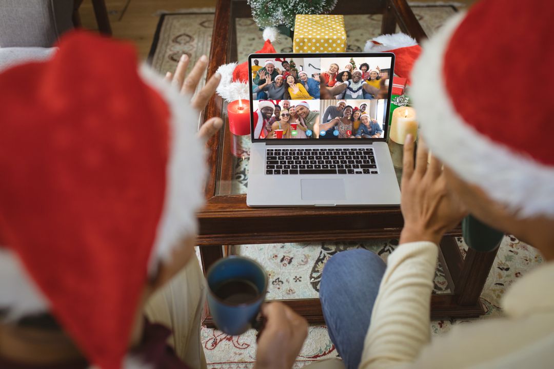 Couple with Santa Hats Having Christmas Video Call With Friends - Free Images, Stock Photos and Pictures on Pikwizard.com