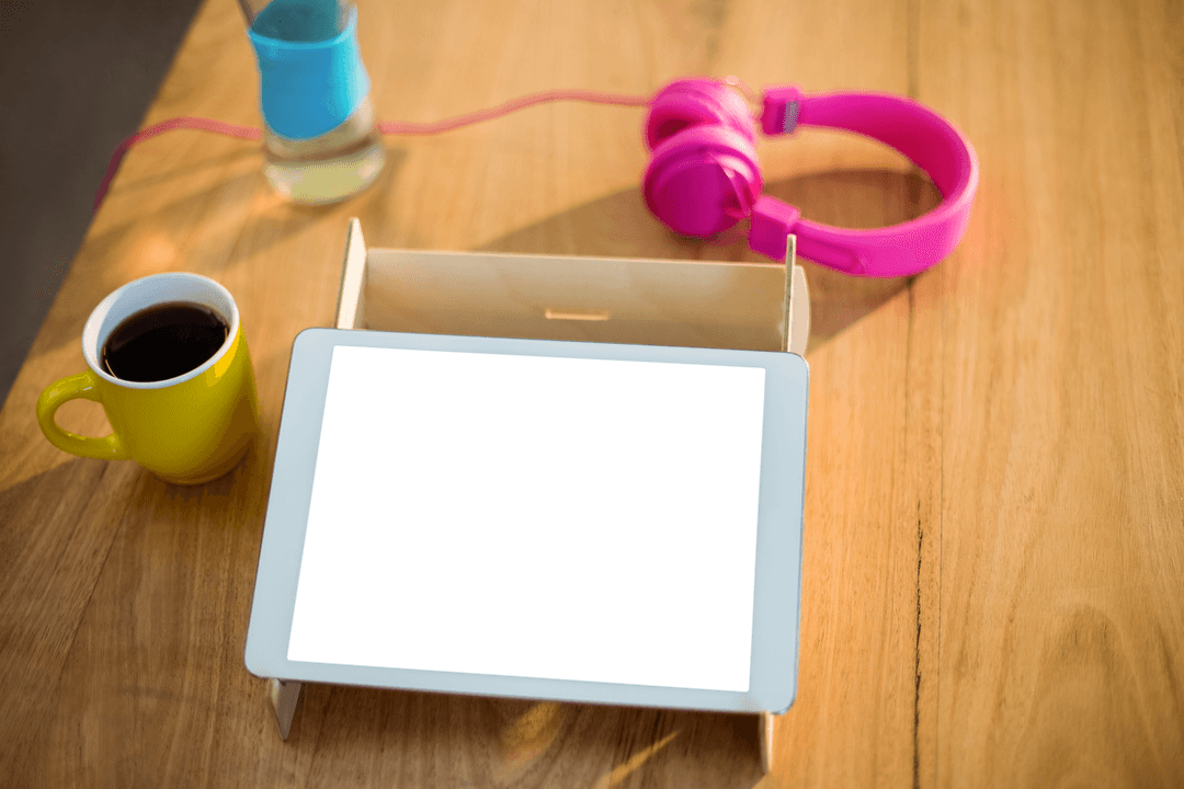 Transparent Screen Mockup of Digital Tablet with Headphones on Wooden Desk