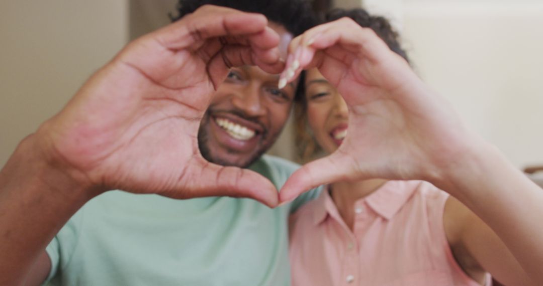 Happy Couple Creating Heart Shape with Hands for Valentine's Day