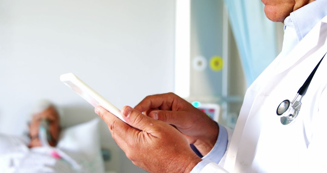 Doctor Using Digital Tablet with Patient in Background - Free Images, Stock Photos and Pictures on Pikwizard.com