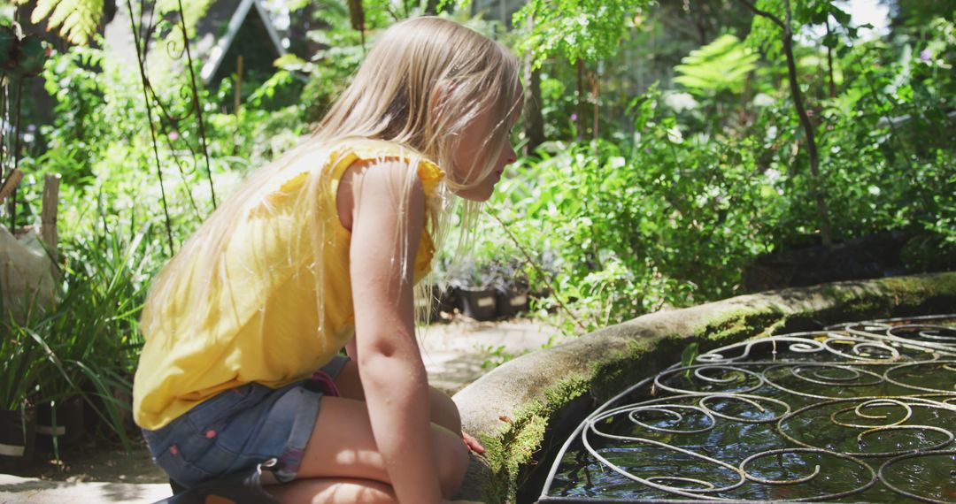 Curious Young Girl Exploring Pond In A Lush Green Garden - Free Images, Stock Photos and Pictures on Pikwizard.com