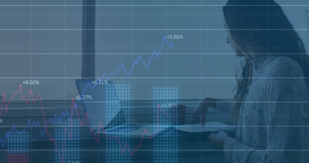 Analyzing Financial Growth Data on Laptop in Modern Office