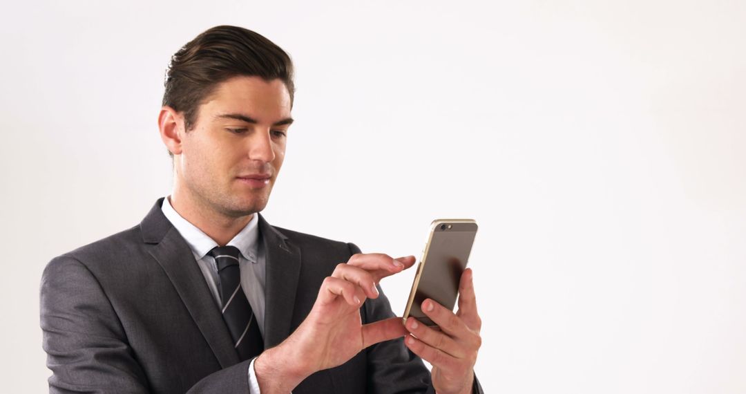 Businessman Using Smartphone Against White Background