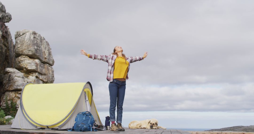 Woman Enjoying Nature Near Tent on Mountainside - Free Images, Stock Photos and Pictures on Pikwizard.com