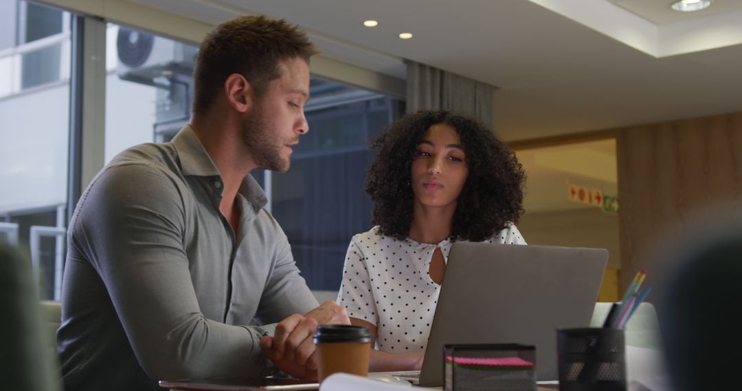 Diverse Professionals Collaborating in Evening Office Workspace