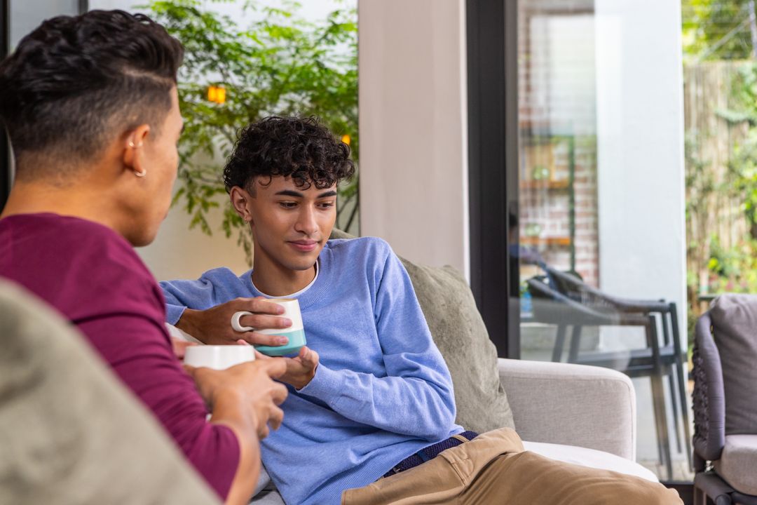 Two Friends Enjoying Coffee in a Cozy Modern Living Room Setting