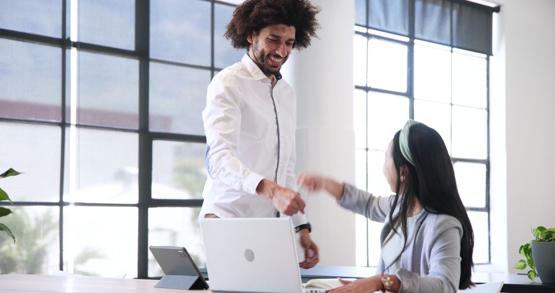 Diverse Business Team Celebrating Success with Technology in Modern Office