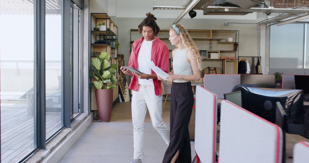 Joyful Team Collaboration with Tablet in Modern Office Setting