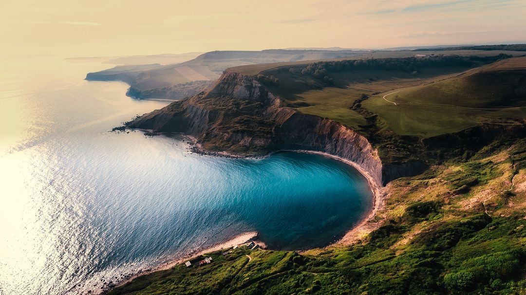 Stunning Aerial View of Coastal Landscape with Cliffs and Blue Sea - Free Images, Stock Photos and Pictures on Pikwizard.com