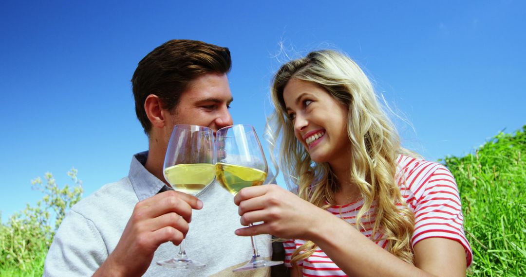 Happy Couple Enjoying Vineyard Picnic with Wine