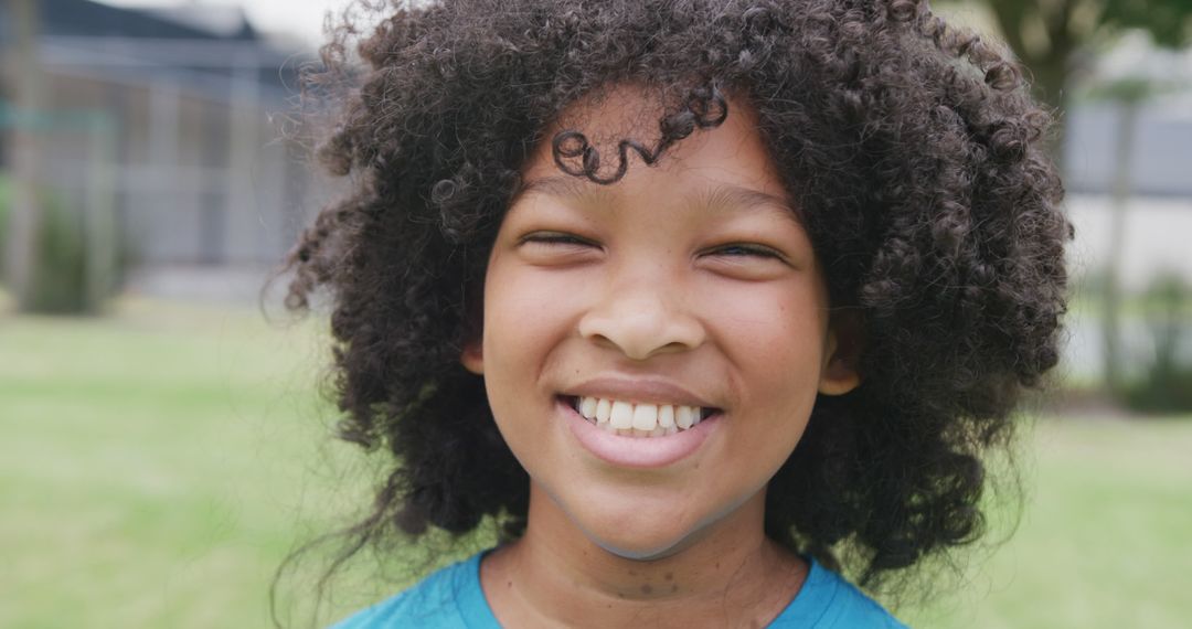 Smiling Girl on School Field Enjoying Day