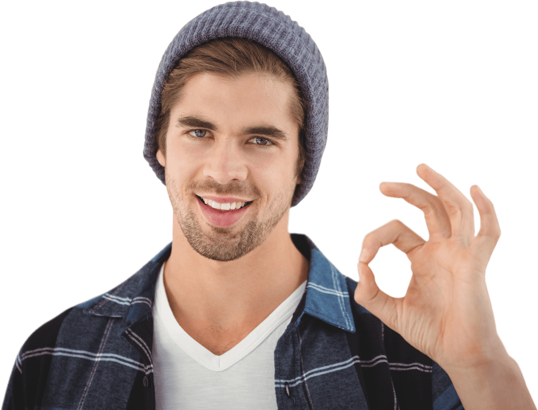 Smiling Young Man in Beanie Making OK Gesture