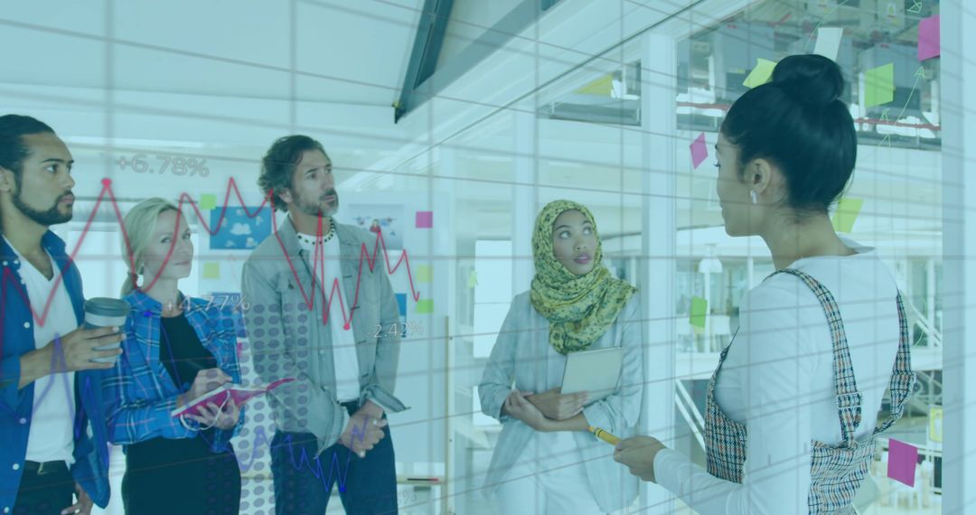 Diverse Team Analyzing Data with Interactive Glass Board