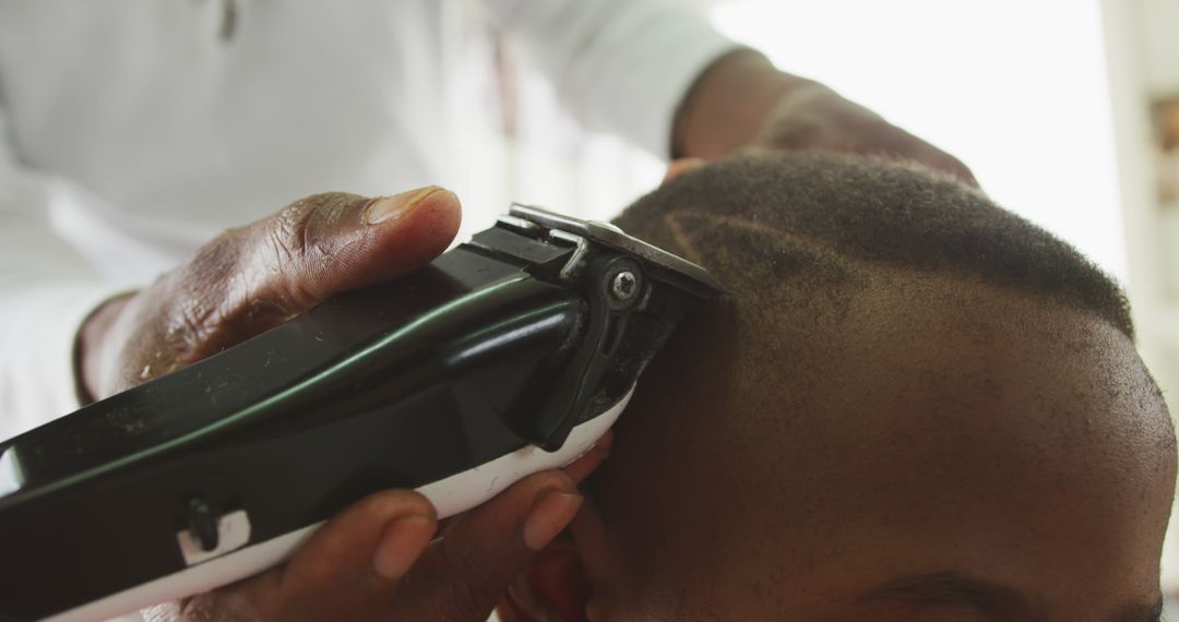 Barber Shaving Young Man's Head with Clippers Close-Up - Free Images, Stock Photos and Pictures on Pikwizard.com